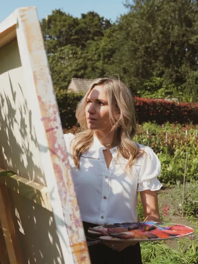 woman standing in front of canvas