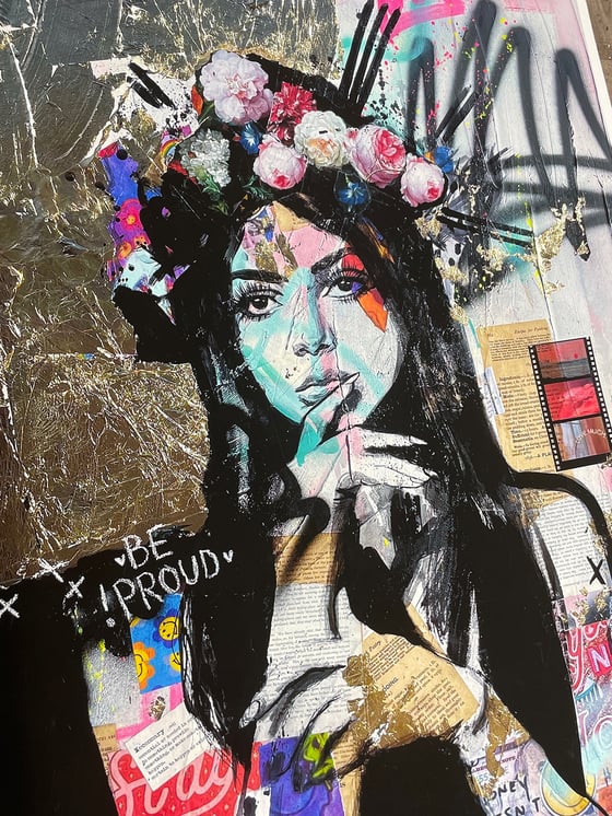 a woman in a flower crown over collage and graffiti, with the words Be Proud